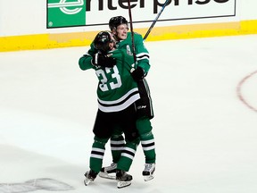 Dallas Stars' Esa Lindell celebrates with John Klingberg after Klingberg scored in overtime against the Nashville Predators in Game 6 of an NHL hockey first-round playoff series in Dallas, Monday, April 22, 2019.