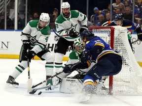 Dallas Stars goaltender Ben Bishop makes the save on St. Louis Blues' Robert Thomas on Saturday afternoon in St. Louis. (Jeff Roberson/The Associated Press)