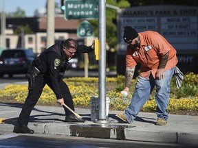 Police and road crews work to clean up the scene after a car crash at the intersection of El Camino Real and Sunnyvale Road in Sunnyvale, Calif., on Wednesday, April 24, 2019. (AP Photo/Cody Glenn)