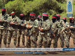 This Monday, Aug 20, 2018 photo provided by the al-Qaida-affiliated Ibaa News Network, shows fighters of the al-Qaida-linked coalition known as Hay'at Tahrir al-Sham, Arabic for Levant Liberation Committee, training in Idlib province, Syria. Al-Qaida-linked militants launched attacks early Saturday, April 27, 2019 on government forces positions in northern Syria killing and wounding dozens in the latest violation of a seven-month truce in the last major rebel stronghold in the country. The caption in Arabic reads: "From inside one of the training centers, the 'Group of Death,' also known as 'Red Group,' belonging to Hay'at Tahrir al-Sham."