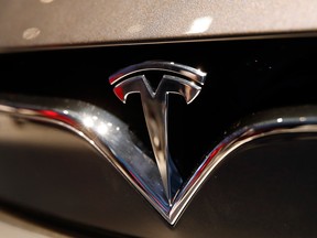 This Oct. 3, 2018, file photo shows a Tesla emblem at the Auto show in Paris.
