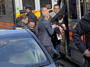 Police bundle WikiLeaks founder Julian Assange from the Ecuadorian embassy into a police van in London after he was arrested by officers from the Metropolitan Police and taken into custody Thursday April 11, 2019.