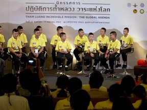 In this Sept. 6, 2018, file photo, members of the Wild Boars, the soccer team that was rescued from a flooded cave, attend a public discussion in Bangkok, Thailand. The U.S. streaming video giant Netflix has officially announced Tuesday, April 30, 2019, it will join with the production company for the movie Crazy Rich Asians to make a film about last July's dramatic rescue of 12 village boys who were trapped with their soccer coach in a flooded cave in northern Thailand for more than two weeks.