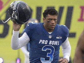 In this Jan. 27, 2019, file photo, NFC quarterback Russell Wilson of the Seattle Seahawks runs onto the field during player introductions before the NFL Pro Bowl football game against the AFC in Orlando, Fla.