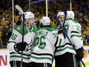 Dallas Stars center Jason Dickinson (16) celebrates with Matts Zuccarello (36), of Norway, and Esa Lindell (23), of Finland, after Dickinson scored a goal against the Nashville Predators during the first period in Game 5 of an NHL hockey first-round playoff series Saturday, April 20, 2019, in Nashville, Tenn.