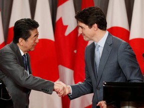 Japanese Prime Minister Shinzo Abe and Canadian Prime Minister Justin Trudeau take part in a welcoming ceremony on Parliament Hill in Ottawa on Sunday, April 28, 2019. (THE CANADIAN PRESS/ Patrick Doyle)