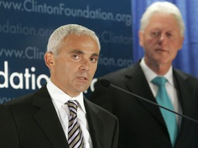 Frank Giustra, a Canadian businessman, speaks as former President Bill Clinton looks on during a news conference to announce the Clinton Foundation's launching of a new sustainable development initiative in Latin America Thursday, June 21, 2007 in New York. A British Columbia businessman and philanthropist is suing Twitter for publishing "false and defamatory" tweets that escalated during the 2016 United States election. Frank Giustra is the founder of Lionsgate Entertainment and CEO of the Fiore Group of Companies, and he's also a member of the board of trustees of the Clinton Foundation.