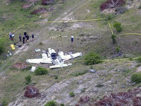 Authorities investigate at the crash scene of a twin-engine Beechcraft BE58, Monday, April 22, 2019, near Kerrville, Texas. The pilot and the five other people aboard the plane were all killed, said Sgt. Orlando Moreno, a spokesman for the Texas Department of Public Safety.