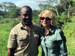 Image released by Wild Frontiers tour company on Monday April 8, 2019, shows American tourist Kim Endicott, right, and field guide Jean-Paul Mirenge a day after they were rescued following a kidnap by unknown gunmen in Uganda's Queen Elizabeth National Park. (Wild Frontiers via AP)