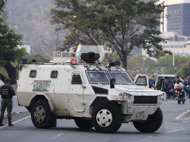 A military vehicle blocks an avenue next to La Carlota air base in Caracas, Venezuela, Tuesday, April 30, 2019.