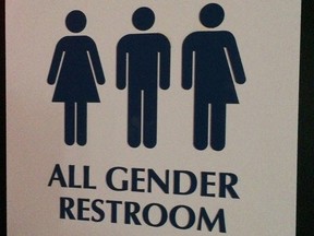This May 11, 2014 photo shows an "All Gender Restroom" sign outside a bathroom in a bar in Washington. (AP Photo)