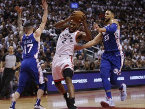 Raptors star Kawhi Leonard cuts between the Philadelphia 76ers' JJ Redick (17) and Ben Simmons on Saturday night in Toronto. (Jack Boland/Toronto Sun)