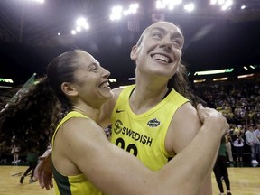 FILE - In this Sept. 4, 2018, file photo, Seattle Storm's Breanna Stewart, right, is embraced by Sue Bird after the Storm defeated the Phoenix Mercury 94-84 during Game 5 of a WNBA basketball playoff semifinal, in Seattle. The WNBA's 23rd season begins May 24, with the Seattle Storm the defending champion.