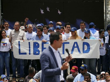 Members of Venezuelan National Assembly holds a sign that reads in Spanish "Freedom" as opposition leader and self proclaimed president Juan Guaido, delivers a speech during a rally in Caracas, Venezuela, Saturday, April 27, 2019.