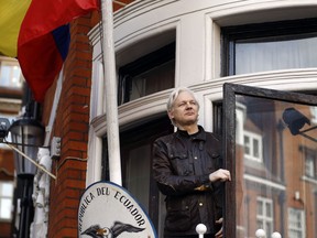 In this Friday May 19, 2017 file photo, WikiLeaks founder Julian Assange greets supporters outside the Ecuadorian embassy in London. (AP Photo/Frank Augstein, File)