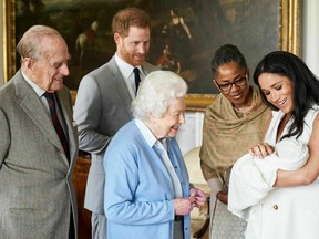 In this image made available by SussexRoyal on Wednesday May 8, 2019, Prince Harry and Meghan, Duchess of Sussex, joined by her mother Doria Ragland, show their new son to Queen Elizabeth II and Prince Philip at Windsor Castle, Windsor, England. (Chris Allerton/SussexRoyal via AP)