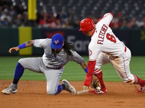 David Fletcher of the Los Angeles Angels of Anaheim beats the tag by Freddy Galvis of the Toronto Blue Jays for a stolen base in the second inning in Anaheim on May 1, 2019.