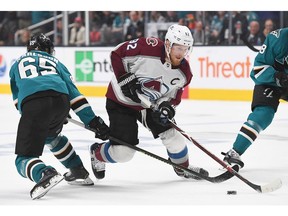 SAN JOSE, CA - MAY 04: Gabriel Landeskog #92 of the Colorado Avalanche controls the puck skating past Erik Karlsson #65 of the San Jose Sharks during the third period in Game Five of the Western Conference Second Round during the 2019 NHL Stanley Cup Playoffs at SAP Center on May 4, 2019 in San Jose, California.