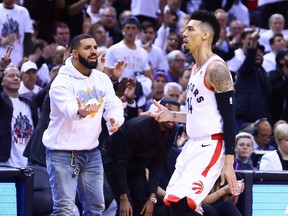 Singer Drake and Danny Green of the Toronto Raptors celebrates a 3 pointer in the second half during Game Five of the second round of the 2019 NBA Playoffs against the Philadelphia 76ers at Scotiabank Arena on May 7, 2019 in Toronto, Canada.  (Vaughn Ridley/Getty Images)