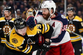 Charlie McAvoy #73 of the Boston Bruins and Boone Jenner #38 of the Columbus Blue Jackets fight during the second period at TD GardenPhoto by Maddie Meyer/Getty Images)