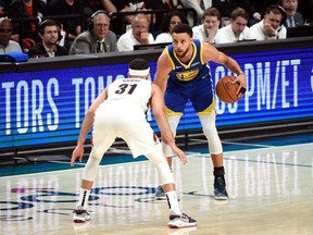 Warriors’ Stephen Curry (right) dribbles against brother Seth of the Trail Blazers during their semifinal series.