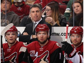 Head coach Dave Tippett of the Arizona Coyotes watches from the bench during the first period of the NHL game against the Vancouver Canucks at Gila River Arena on November 23, 2016 in Glendale, Arizona.