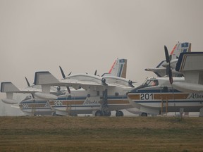 Water bombers are seen on the tarmac of the Slave Lake Airport on a smoky evening due to nearby wildfires in Slave Lake, on Thursday, May 30, 2019.