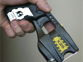 A police officer displays the Taser X26, the model currently in use by The Winnipeg Police Service.