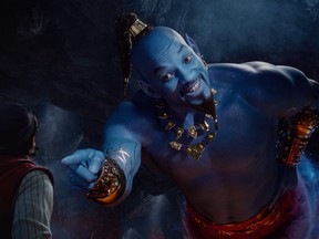 This image released by Disney shows Mena Massoud as Aladdin, left, and Will Smith as Genie in Disney's live-action adaptation of the 1992 animated classic "Aladdin."