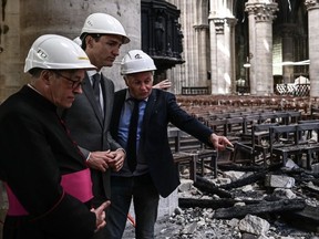 French chief architect of Historical Sites Philippe Villeneuve (R) speaks to Canadian Prime Minsite Justin Trudeau (C) and Notre Dame cathedral rector Patrick Chauvet as they visit the Notre Dame de Paris Cathedral in Paris on May 15, 2019, after it sustained major fire damage the previous month. PHILIPPE LOPEZ/AFP/Getty Images