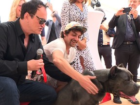 Director Quentin Tarantino poses with stand-in hound Haru as he attends the Palm Dog on the sidelines of the 72nd edition of the Cannes Film Festival in Cannes, southern France, on May 24, 2019. (NATALIE HANDEL/AFP/Getty Images)
