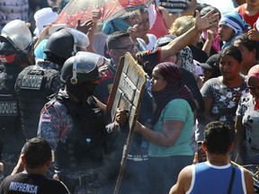Relatives argue with police for more information outside the Anisio Jobim Prison Complex where a deadly riot erupted among inmates in Manaus in the northern state of Amazonas, Brazil, Sunday, May 26, 2019. A statement from the state prison secretary says prisoners began fighting among themselves around noon Sunday, and security reinforcements were rushed to complex.
