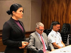 UFC fighter Rachael Ostovich Berdon, standing, speaks to a judge in state court in Honolulu on Thursday, May 16, 2019 as her husband, mixed martial arts fighter Arnold Berdon, far right, and Berdon's attorney, Myles Breiner, listen.