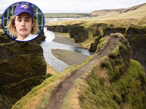 This photo taken Wednesday, May 1, 2019, shows a cliff at the Fjadrargljufur canyon in southeastern Iceland. The canyon area has suffered environmental damages after intense traffic, prompted by the music video "I'll Show You" by Justin Bieber (inset).