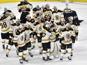 The Bruins celebrate after defeating the Hurricanes in Game 4 to win the NHL's Eastern Conference Finals at PNC Arena in Raleigh, N.C., on Thursday, May 16, 2019.