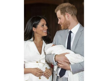 In this Wednesday, May 8, 2019 file photo, Prince Harry and Meghan, Duchess of Sussex smile during a photocall with their newborn son, in St George's Hall at Windsor Castle, Windsor, south England.
