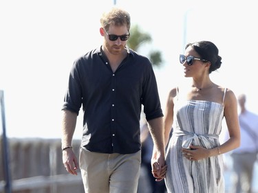 In this Monday, Oct. 22, 2018 file photo, Prince Harry and Meghan, Duchess of Sussex walk along the Kingfisher Bay Jetty,  in Fraser Island, Australia.