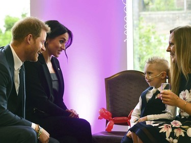 In this Tuesday, Sept. 4, 2018 file photo, Prince Harry, the patron of the charity WellChild and his wife Meghan, the Duchess of Sussex meet four-year-old Mckenzie Brackley and his mother, during the annual WellChild Awards at the Royal Lancaster Hotel in London.