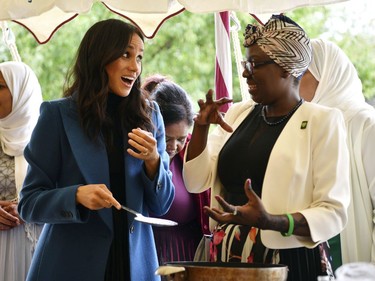 In this Thursday, Sept. 20, 2018 file photo, Meghan, the Duchess of Sussex, left, reacts with one of the women behind the cookbook "Together" during a reception at Kensington Palace, in London.