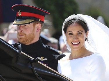 In this Saturday, May 19, 2018 file photo, Britain's Prince Harry and his wife Meghan Markle leave after their wedding ceremony, at St. George's Chapel in Windsor Castle in Windsor, near London, England. Sunday, May 19, 2019 marks the first wedding anniversary of the couple.