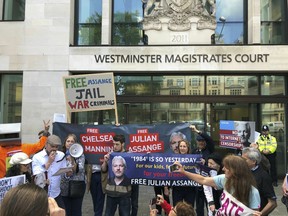Julian Assange supporters gather outside Westminster Magistrates Court in London, Thursday May 30, 2019.