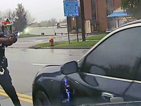 This still image from police dash camera video released Friday, May 3, 2019, by the Hartford State's Attorney shows Police Officer Layau Eulizier pointing his weapon at a car being driven at him by Anthony Jose Vega Cruz during an attempted traffic stop April 20 in Wethersfield, Conn.
