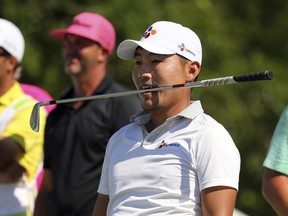 Sung Kang holds his club in his teeth after his shot of the 12th tee n the final round of the Byron Nelson golf tournament on Sunday, May 12, 2019, in Dallas.