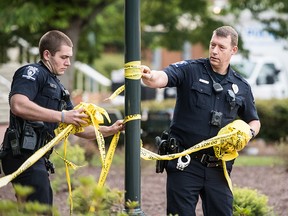 Charlotte-Mecklenburg law enforcement removes crime scene tape in front of the Kennedy building where a gunman killed two people and injured four students at UNC Charlotte May 1, 2019 in Charlotte, N.C. (Sean Rayford/Getty Images)