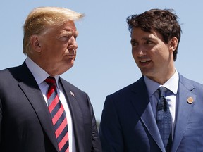 U.S. President Donald Trump talks with Prime Minister Justin Trudeau during a G7 Summit on June 8, 2018.