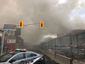 Smoke fills the air as flames shoot out the roof of York Memorial Collegiate Institute on Tuesday, April 7, 2019. (ChiefPeggTFS/Twitter)