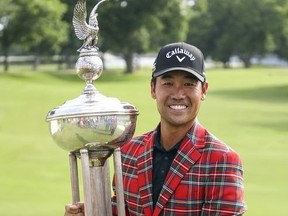 Kevin Na holds the Leonard Trophy after winning the Charles Schwab Challenge golf tournament Sunday, May 26, 2019, in Fort Worth, Texas.