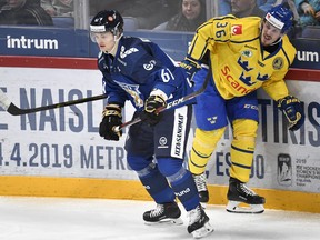 Teemu Kivihalme of Finland, left, and Emil Larsson of Sweden during the Ice Hockey Euro Hockey Tour Karjala Cup match between Finland and Sweden in Helsinki, Finland, on Sunday, November 11, 2018. (THE CANADIAN PRESS/Heikki Saukkomaa/Lehtikuva via AP)