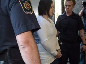 Terri-Lynne McClintic, convicted in the death of eight-year-old Woodstock, Ont., girl Victoria Stafford, is escorted into court in Kitchener, Ont., on Wednesday, Sept. 12, 2012 for her trial in an assault on another inmate while in prison.
