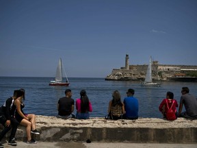 People look at American sailboat racers during a regatta at the Malecon in Havana, Cuba, Saturday, May 4, 2019. .
